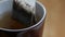 Steam rises over boiling water in brown porcelain cup for hot drink preparation