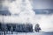 Steam rising from geyser creates localized snow falling