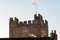 Steam rising from rooftops with Richmond Castle Keep in the background. Bathed in the golden sunlight of early morning