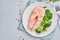 Steam salmon, broccoli, paleo, keto or fodmap diet. White plate on blue table, top view, copy space