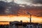Steam or smoke comes from the pipes. Thermal power station plant in the city. Landscape at sunset or dawn in the skyline