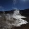 Steam with sun reflection on the water in El Tatio Chile