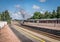 A steam train, bellowing steam and smoke at the aviemore train station