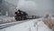 Steam train ride in winter snow travel scene.