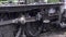 Steam train starts to move close up of wheels and steam 4K