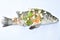 Steamed bass fish with garlic dipping spicy sauce on white background