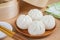 Steamed buns on wooden plate and bamboo steamer basket