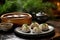 steamed dumplings on an artisanal pottery plate near a bonsai tree