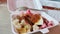 Steamed dumplings with eggs, crackers, vegetables, potatoes and peanut sauce