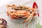 Steamed Fresh Flower Crabs in glass bowl with red crab cracker