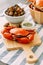 Steamed Giant Mud Crab on wooden chopping board served with Thai spicy seafood sauce and Grilled Laevistrombus Canarium in shell.