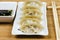 Steamed gyoza dumplings on white plate.