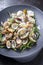 Steamed Japanese carpet shell with blanched green salicornia on a modern design plate