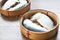 Steamed mackerels in basket on wooden table