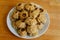 Steamed national Mongolian food dumpling Buuz filled with minced beef, white plate, wooden table, Close up east Siberian Buryats