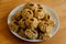 Steamed national Mongolian food dumpling Buuz filled with minced beef, white plate, wooden table, Close up east Siberian Buryats