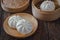 Steamed pork buns on wooden plate, Chinese dim sum