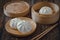 Steamed pork buns on wooden plate, Chinese dim sum