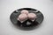 Steamed purple sweet potato chinese buns on black shiny plate is