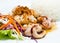 Steamed rice with fried squid with garlic and pepp