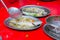 Steamed sea bass fish with lemon, Thai famous local food served on fish shape plate. Thai recommend menu for tourist. Steamed fish