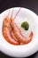 Steamed shrimps on ice on white plate with broccoli