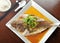 Steamed whole Grouper fish in soy sauce of Chinese cooking style and garnish with shre