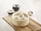 Steamed Xiao Long Bao served in a wooden bowl isolated on mat side view on grey background