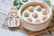 Steamed xiaolongbao served in a traditional steaming basket