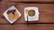 Steaming coffee with sweets on wooden table. Hot freshly brewed espresso coffee in white cup with steam. Crunchy cookies chocolate