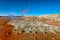 Steaming cone in Hverir geothermal area with boiling mudpools and steaming fumaroles in Iceland