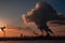 Steaming cooling towers and smoking industrial stacks against sunset gradient sky