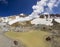 Steaming crater of active volcano covered by snow