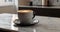 A steaming cup of coffee sits on a white marble countertop, surrounded by roasted beans, in a modern kitchen setting