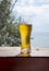 A steaming glass of beer stands on the bar