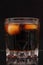 A steaming glass of cold thirst-quenching red-brown drink with ice cubes