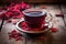 a steaming hibiscus tea cup on a rustic wooden table with scattered tea leaves