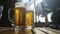 A steaming mug of cold beer on the table of a summer cafe