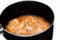 Steaming pan of chicken curry being prepared