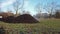 Steaming pile of manure on farm field in the winter