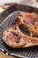 Steaming pork chops on grill frying pan