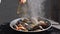 Steaming stewed mussels in white dry wine sauce with garlic and tomato. Cooking mediterranean molluscs in shell for