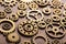 Steampunk mechanical cogs gears wheels on wooden background