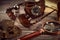 Steampunk still life - old vintage objects on a wooden background. Leather wrist watch, dark glasses, old tube lamps, magnifying g