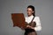Steampunk woman using vintage laptop isolated on grey