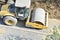 Steamroller performing leveling work on a road under construction. Equipment for construction and repair roads. Yellow steamroller