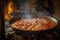 Steamy Paella cooking in a traditional Spanish kitchen with saffron, chorizo and prawns