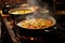 steamy paella cooking in a traditional spanish pan