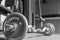 The steel barbell dumbbell in a gym muscle-building black and white image, life and fitness concept with copy space