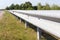 Steel beams road crash barrier on the roadside of roadway